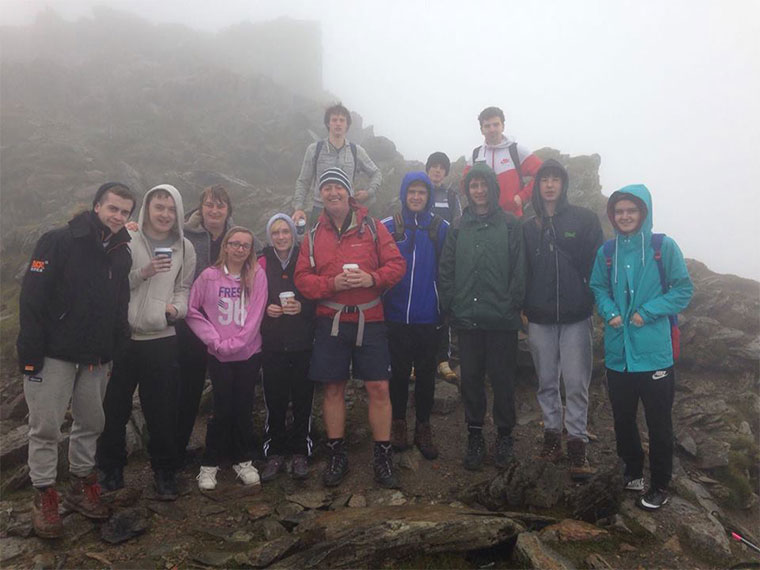 Level 2 Sport students group up for a photo atop of Snowdon.