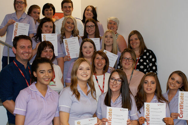 Healthcare students smile with their awards.