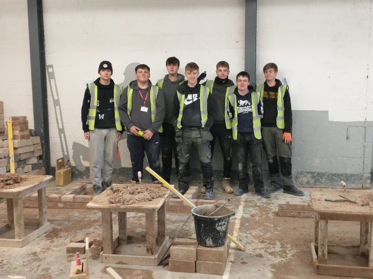 An image of the Construction students that competed in the inter-college competition stood in the workshop.