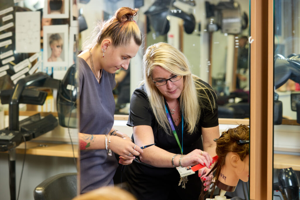 Image of a hairdressing student training in the salon