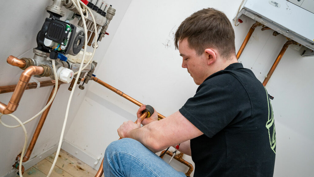 A plumbing student at North Notts College