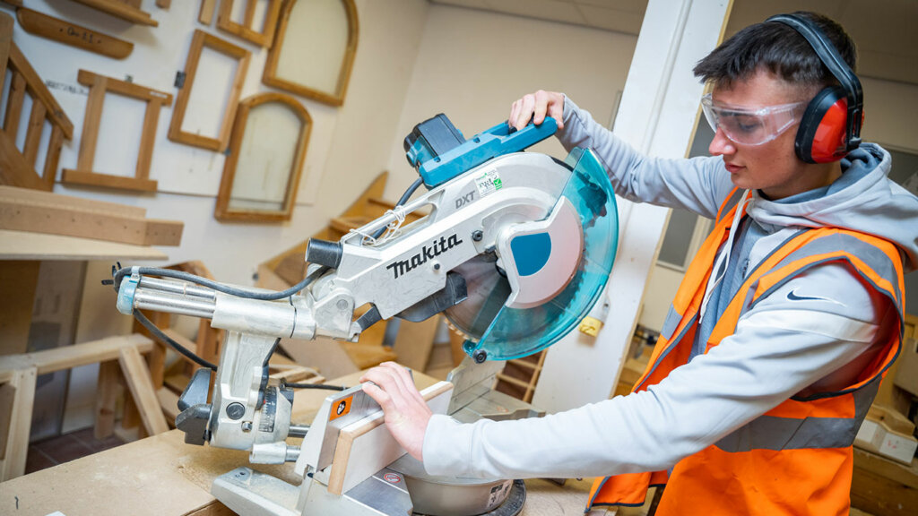 A joinery student working machinery at North Notts College